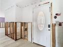 Foyer with updated door and partially exposed wall frames at 4745 Floramar Ter, New Port Richey, FL 34652