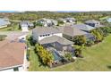 Aerial view of a screened-in pool and lush landscaping in a residential neighborhood at 7048 White Willow Ct, Sarasota, FL 34243