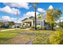 Well-maintained house featuring a lush green lawn, mature landscaping, and an inviting facade at 901 W Plymouth St, Tampa, FL 33603