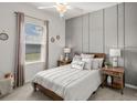 Comfortable bedroom with natural light, featuring a queen-size bed, stylish nightstands, and modern decor at 2432 White Ladyfish Rd, Wimauma, FL 33598