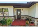 Inviting front entrance featuring a decorative door, stone accents, and well-maintained landscaping at 5104 Saint Charles Pl, Tampa, FL 33610