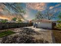Spacious backyard featuring a detached garage and paved parking area at 923 26Th N St, St Petersburg, FL 33713