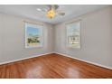 Bright bedroom with hardwood floors, neutral paint, and two windows at 923 26Th N St, St Petersburg, FL 33713
