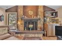 Living room stone fireplace with wooden mantle and hearth, with a wood-paneled accent wall at 1316 Cambron Dr, Valrico, FL 33596