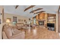 Cozy living room with exposed wood beams, fireplace, and laminate wood flooring at 1316 Cambron Dr, Valrico, FL 33596