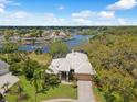 Sprawling waterfront property with a private dock, lush landscaping, and a serene view of the water at 5903 Cachette De Riviera Ct, New Port Richey, FL 34655