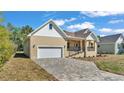 Well-maintained home with a two-car garage and a brick-paved driveway at 12500 Green Oak Ln, Dade City, FL 33525