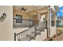 Inviting front porch with stylish railings and exterior lighting at 12500 Green Oak Ln, Dade City, FL 33525