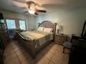 Bedroom with a king-size bed, a ceiling fan, and double glass patio doors at 3133 Washington Rd, Valrico, FL 33594