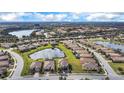 Expansive aerial view showcases a well-planned community with lakes and lush landscaping at 6914 Quiet Creek Dr, Bradenton, FL 34212