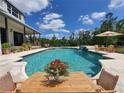 Beautiful in-ground pool with lush landscaping and inviting patio furniture, perfect for outdoor relaxation at 8922 Pritcher Rd, Lithia, FL 33547