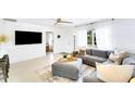 Bright and airy living room with neutral tones, a ceiling fan, and a large window at 1046 Lee St, Englewood, FL 34224
