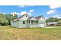 Charming single-story home with an attached garage and a well-maintained lawn at 12484 Green Oak Ln, Dade City, FL 33525