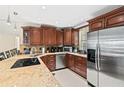 Well-equipped kitchen boasting stainless steel appliances and granite countertops at 605 Sutton Pl # 102, Longboat Key, FL 34228