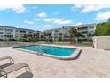 Beautiful community pool with lounge chairs and meticulously kept landscaping at 605 Sutton Pl # 102, Longboat Key, FL 34228