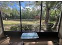 Relaxing screened porch with peaceful views of lush greenery and a tranquil pond at 3232 Lake Pine E Way # G1, Tarpon Springs, FL 34688