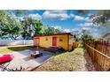Cozy backyard with patio area, perfect for outdoor gatherings and grilling, framed by lush greenery at 4022 Watson Rd, Tampa, FL 33610