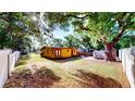 View of backyard featuring mature trees and a shed at 4022 Watson Rd, Tampa, FL 33610