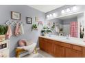 Stylish bathroom features double sinks, vanity, and decorative elements at 2125 Wild Grape Pl, Riverview, FL 33578