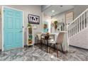 Open dining area with cute decor, an accent wall, and a bright blue door for a pop of color at 2125 Wild Grape Pl, Riverview, FL 33578