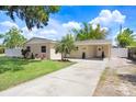 Charming single-story home featuring a well-manicured lawn and an extra long driveway at 1411 Fernwood Pl, Seffner, FL 33584