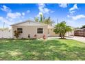 Charming single-story home featuring a well-manicured lawn and a welcoming brick facade at 1411 Fernwood Pl, Seffner, FL 33584