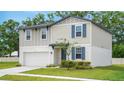 Charming two-story home featuring a fresh white garage door, and delightful blue shutters against neutral siding at 203 Lovely Ct, Plant City, FL 33566