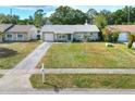 Inviting one-story home with a spacious front yard, driveway, and charming curb appeal at 13032 Cumberland Dr, Largo, FL 33773