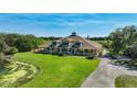Picturesque aerial view of home situated on expansive property, with large lawn, lake and private drive at 701 E 60 Hwy, Plant City, FL 33567