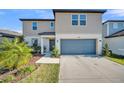 Charming two-story home with neutral siding, a two-car garage, and well-maintained landscaping at 1009 Golden Shiner Ave, Ruskin, FL 33570