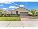 Charming single-story home with a brick driveway and beautifully landscaped front yard at 3134 Macintosh Rd, Land O Lakes, FL 34639