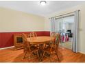 Dining area with a wooden table, chairs, and sliding glass doors that provide access to the outside at 115 W Lee St, Plant City, FL 33563