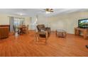 Inviting living room featuring warm wood floors, comfortable seating, and a seamless flow to the dining area at 115 W Lee St, Plant City, FL 33563