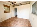 Bright bonus room featuring tile flooring, a ceiling fan, and a window at 2415 Goldenrod St, Sarasota, FL 34239