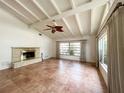 Bright living room with tile flooring, a fireplace and beamed ceilings at 2415 Goldenrod St, Sarasota, FL 34239
