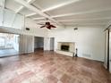 Bright living room featuring tile floors, fireplace, ceiling fan, and large windows at 2415 Goldenrod St, Sarasota, FL 34239