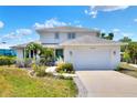 Two-story home featuring a lush landscaped yard, two car garage, and a beautiful green front door at 4116 4Th Ne Ave, Bradenton, FL 34208
