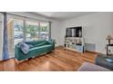 Cozy living room with large window, hardwood floors, and contemporary furnishings, creating a comfortable ambiance at 114 Windy Pl, Brandon, FL 33511