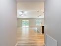 Inviting living space with wood flooring, modern lighting fixtures, and sliding glass doors to outdoor patio at 12043 Centralia Rd, Weeki Wachee, FL 34614