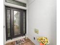 Elegant front door with decorative glass, a welcome mat, and a charming sunflower arrangement at 20159 Umbria Hill Dr, Tampa, FL 33647