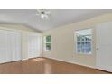 Bright bedroom featuring wood floors, a ceiling fan and double closets at 625 Chilt Dr, Brandon, FL 33510