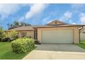 Charming single-story home with a well-manicured lawn and attached two-car garage at 625 Chilt Dr, Brandon, FL 33510