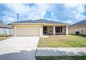 Charming one-story home featuring a two-car garage, well-maintained lawn, and a screened-in front porch at 727 Vineyard Reserve Ct, Seffner, FL 33584