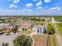 A peaceful neighborhood aerial view showcasing a pond, well-kept yards, and attractive homes in a serene setting at 12214 Citrus Leaf Dr, Gibsonton, FL 33534