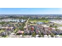 Aerial view of a neighborhood with house, showcasing lush greenery, community ponds, and landscaping at 1401 Parker Den Dr, Ruskin, FL 33570