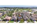 Aerial view of a neighborhood, showcasing house with lush greenery and nearby ponds at 1401 Parker Den Dr, Ruskin, FL 33570