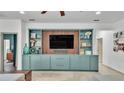 Stylish living room with built-in shelving and drawers, and decorative items on the shelves at 15706 Starling Water Dr, Lithia, FL 33547