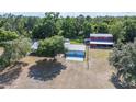 Wide aerial view of the home, the garage and what appears to be a barn outbuilding at 4020 Mcintosh Rd, Dover, FL 33527