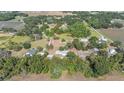 Aerial view of a sprawling property showcasing the home, outbuildings, and land boundary at 4020 Mcintosh Rd, Dover, FL 33527