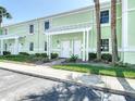Beautiful two-story condo featuring a pergola over the entrance and lush landscaping at 4778 Coquina Key Se Dr # 4778, St Petersburg, FL 33705
